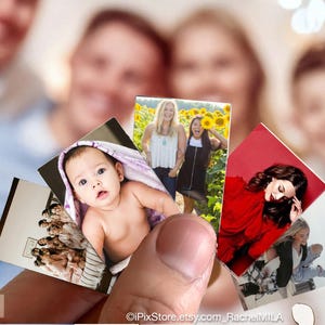 May include: A set of five photo cards featuring different people. The cards are held in a hand and are arranged in a fan shape. The cards are printed with photos of a baby, a woman in a red dress, two women in a field, and a woman in a blue shirt.