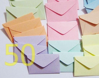 May include: A set of 50 pastel colored envelopes. The envelopes are in shades of light blue, light green, light pink, light orange, and lavender.