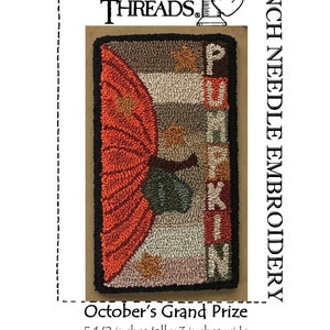 May include: Punch needle embroidery with a pumpkin design and the word "PUMPKIN". The artwork is 14 cm tall and 7.6 cm wide. The design includes orange, brown, and green. The text "October's Grand Prize" is also included.