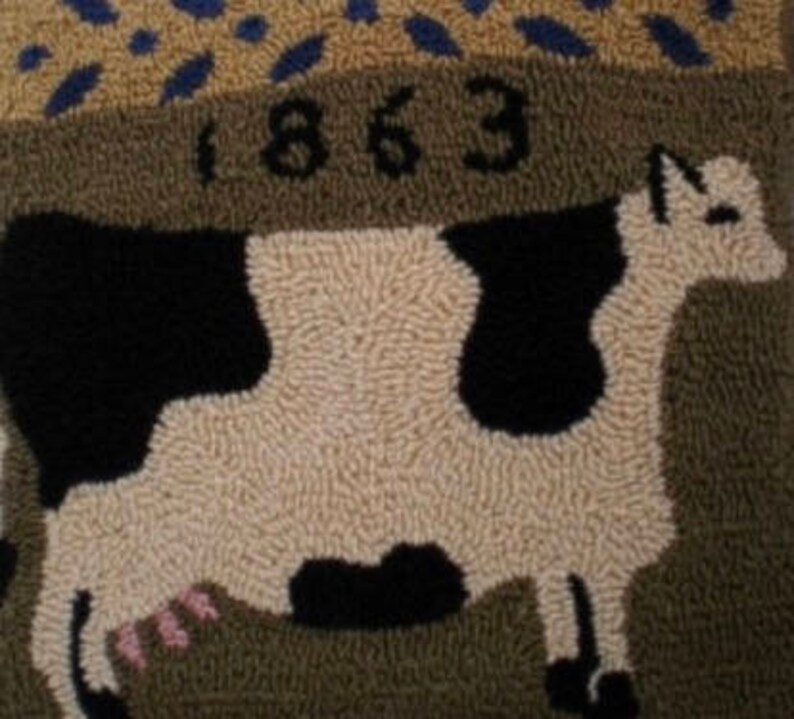 May include: A brown and white rug with a black and white cow design. The rug has the year 1863 stitched into it.