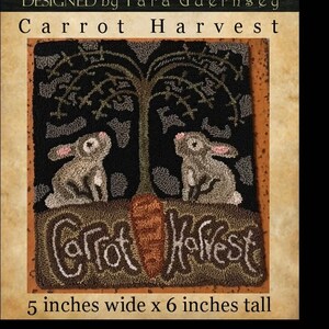 May include: A needlepoint rug depicting two rabbits sitting under a tree with a large carrot in the foreground. The rug is brown, green, and gray with the text "Carrot Harvest" in the bottom center. The rug is 5 inches wide and 6 inches tall.