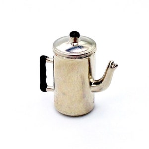 May include: A silver metal coffee pot with a black handle and a lid. The pot has a spout on the side.