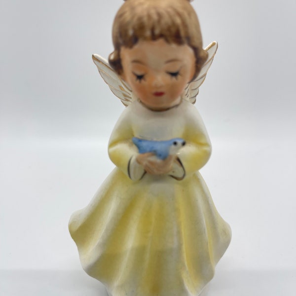 Cute March Angel with a yellow dress holding a Blue Bird