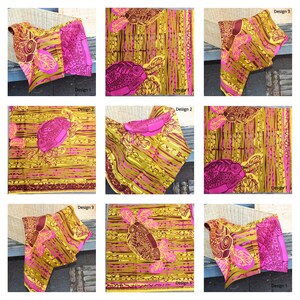 May include: A close-up of nine different fabric designs featuring a pink and gold pattern with a stylized turtle and leaf design. The fabric is folded and displayed on a wooden surface.