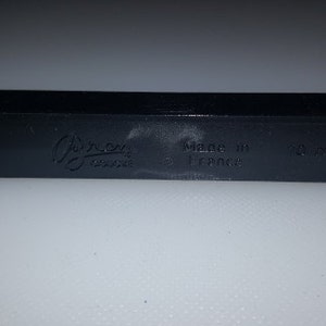 May include: A black plastic rectangular box with the text "Gilroy Design" and "Made in France" printed on it.