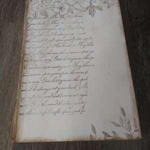 May include: A handwritten note with a floral design on the top and bottom. The note reads: "litysk in the palm of His hand your bank May he sunshine until we meet agains my God hold you May the mind be always in ward the miss fell soft upon your fields, and a vale palen of His hand. Mayither ack May the sunshine warm spon ye nere agam may God hold you in the ju be wadrisonpetermeet you. May therein incwarm spon your face, therains f zair, may God hold you in the pal wid he always at your back Mr y, fiches and antil we meet agai May the wind be atwe ys cate xe the rains fall soft spongeakhe"