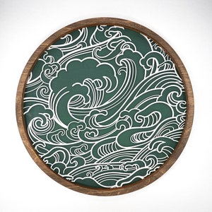 May include: A round wooden wall decoration with a green background and a white wave pattern.