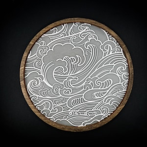 May include: A round wooden tray featuring a white wave pattern design. The tray is crafted from wood and has a natural finish.