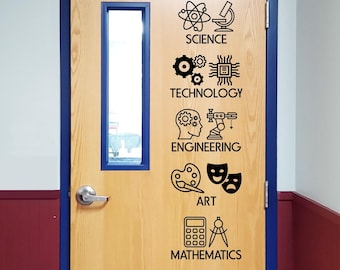 May include: A light wood door with a blue frame and a vertical rectangular window. Black vinyl decals are applied to the door, featuring icons and labels for Science, Technology, Engineering, Art, and Mathematics, arranged in a vertical column.