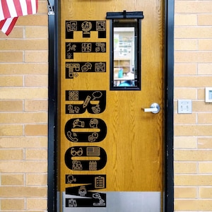 May include: A wooden door featuring a large black vertical decal that spells the word ELA ROOM. The letters are filled with various white line-art icons representing educational themes, including a globe, books, maps, pencils, and speech bubbles.