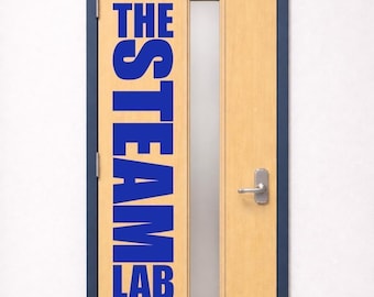 May include: A light wood door with a dark blue frame, featuring a vertical blue decal that reads THE STEAM LAB. The door includes a narrow rectangular frosted glass window, a silver metal handle, and a silver kick plate at the bottom.