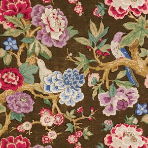 May include: A brown fabric with a floral pattern featuring pink, purple, blue, and white flowers. The fabric also has a pattern of birds and branches.