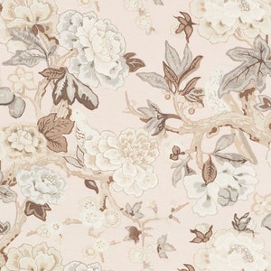 May include: A pink fabric with a floral pattern featuring white and brown flowers, leaves, and birds. The pattern is repeated throughout the fabric.