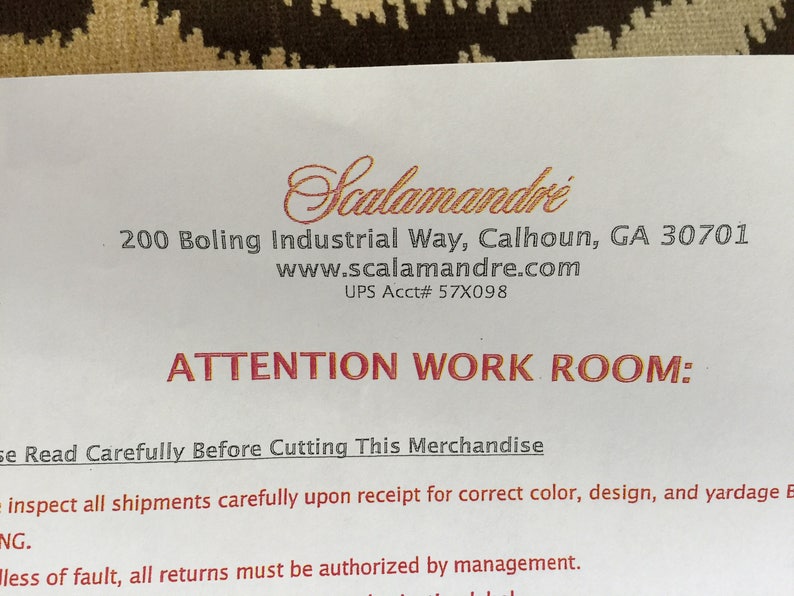 May include: A white document with black and red text featuring the Scalamandr&eacute; logo at the top. The text includes the address 200 Boling Industrial Way, Calhoun, GA 30701, the website www.scalamandre.com, UPS Acct# 57X098, and the heading ATTENTION WORK ROOM: