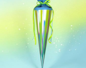 May include: A conical gift container featuring a metallic lime green and silver holographic finish. The top is closed with a blue fabric insert tied with a bright lime green ribbon that hangs down in long, thin strands on both sides of the cone.