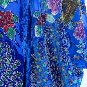 May include: A blue velvet kimono with a sheer overlay featuring embroidered peacocks and floral designs in shades of green, purple, and red.