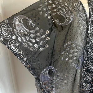 May include: Black sheer shawl with silver sequins and peacock embroidery.