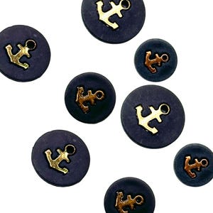 May include: A set of eight navy blue buttons with gold anchor accents. The buttons are round and have a smooth, matte finish.