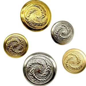 May include: Five decorative buttons with a swirling design. Two buttons are gold, two are silver, and one is a smaller gold button.