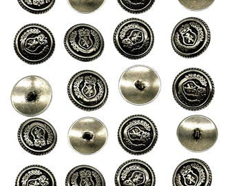 May include: Twenty silver-toned buttons with a decorative design featuring a crown and a lion. The buttons have a raised edge and a smooth, flat back.