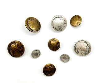 May include: A collection of eight vintage-style buttons featuring a profile of a Native American. The buttons are made of metal and have a silver and gold finish.