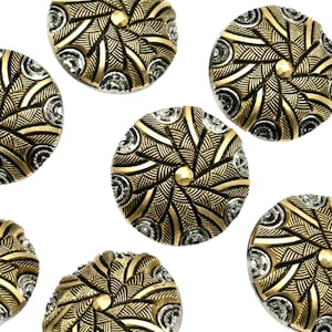 May include: A set of ten gold and silver decorative buttons with a swirling, geometric design. The buttons are round and have a raised centre.
