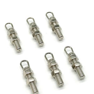 May include: Six silver-toned metal hooks with a loop at the top and two nuts. The hooks are approximately 5 cm long.