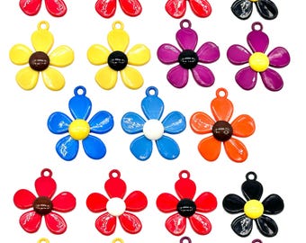May include: Assortment of 15 colorful metal flower charms with different colored centers. The charms are in red, yellow, blue, orange, purple, and black.