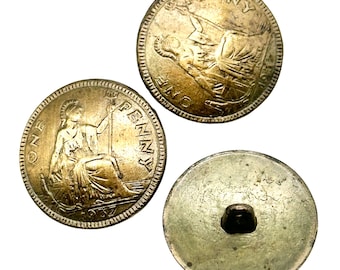 May include: Three gold-colored metal buttons with the inscription "ONE PENNY" and a depiction of a seated woman. The back of one button shows a metal loop.