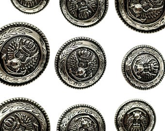 May include: Ten silver-toned buttons with an ornate design featuring a crown, wings, and an anchor. The buttons have a textured, circular shape with a raised design.