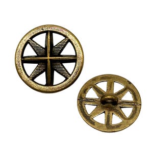 May include: Two antique gold metal buttons with a circular design featuring a starburst pattern. The buttons have a hole in the centre for sewing.
