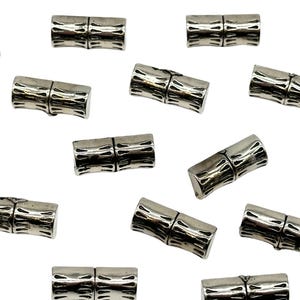 May include: A set of 12 silver-toned magnetic clasps for jewelry making. Each clasp is designed to look like a piece of bamboo.