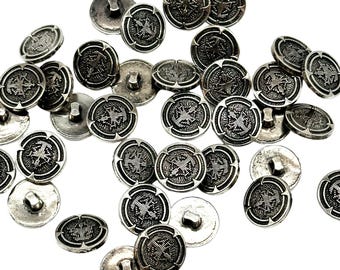 May include: A collection of silver-toned buttons with a decorative design. The buttons are round and have a raised design in the center.