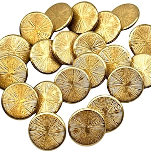 May include: A group of 18 gold-toned buttons with a textured, sunburst design. The buttons are round and have a smooth, shiny finish.