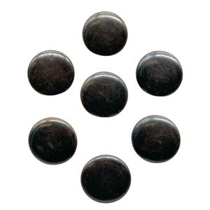 May include: Seven round, black metal buttons.
