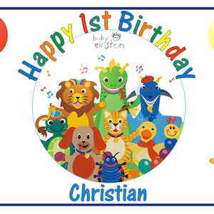 May include: A colorful banner with the text "Happy 1st Birthday" and the name "Christian" at the bottom. The banner features a circle with a Baby Einstein logo and a group of cartoon animals playing music. There are balloons in various colors around the circle.