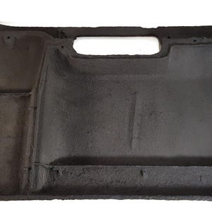May include: Black automotive part with a textured surface and multiple cutouts. The part has a rectangular shape with rounded corners.