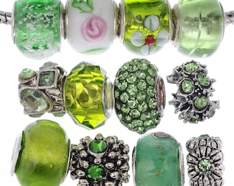 May include: A set of ten green and silver charm beads. The beads are made of glass, metal, and crystals. Some of the beads have floral designs, while others have geometric patterns.