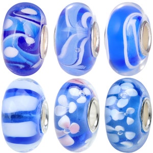 May include: Six blue glass beads with white and pink designs. The beads have a silver metal core and are ideal for jewellery making.