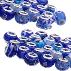 May include: A collection of blue glass beads with silver accents. The beads have various patterns and designs, including swirls, stripes, and dots.