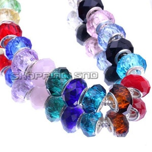 May include: A colorful charm bracelet with silver beads and crystal charms in various colors, including blue, green, purple, and red.