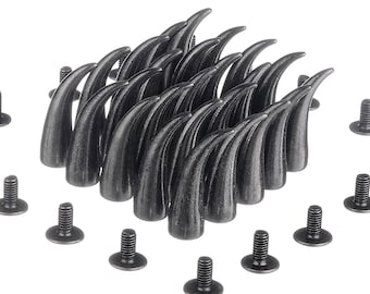 May include: A set of 25 black metal claw-shaped studs with a pointed tip. The studs are arranged in a pyramid shape and are surrounded by 10 black metal screws with flat heads.