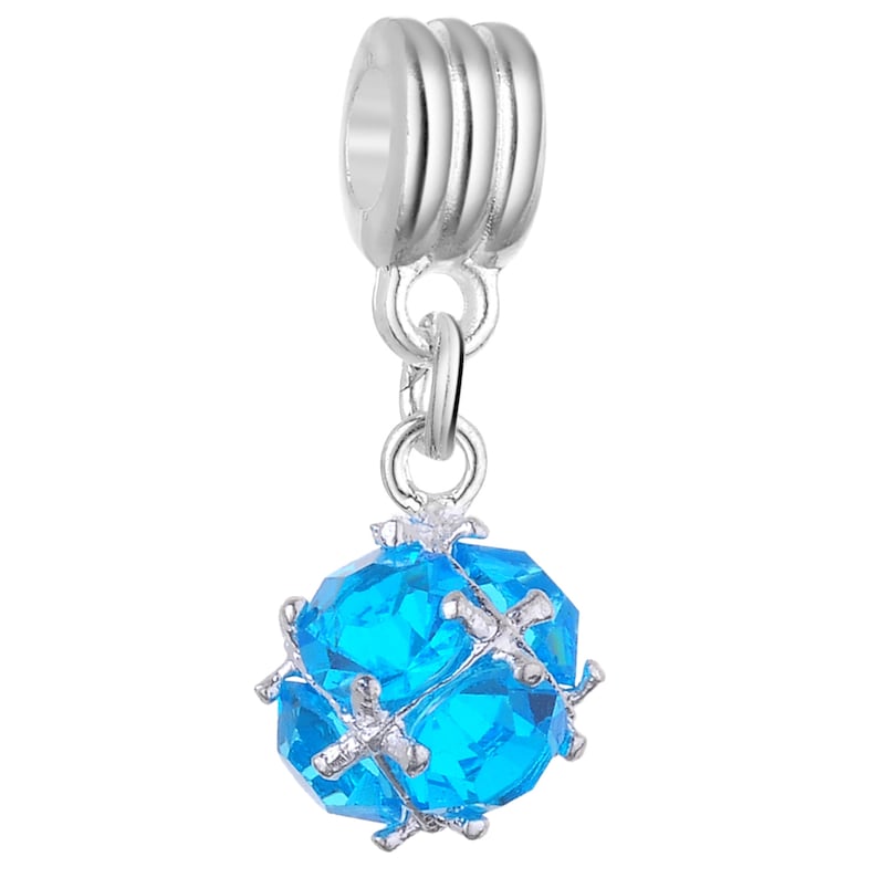 May include: A silver charm featuring a blue crystal ball. The ball is faceted and has a silver frame. The charm has a silver loop for attaching to a bracelet or necklace.