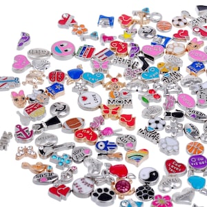 May include: A large collection of colorful charm beads for jewelry making. The charms feature various designs, including hearts, animals, words, and symbols.
