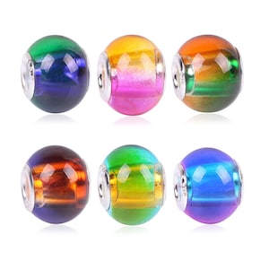 May include: Six round glass beads with silver accents. Each bead has a different color gradient, including green, blue, pink, orange, and yellow.