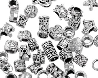 May include: A collection of silver charm beads for jewellery making. The beads feature various designs, including hearts, stars, animals, and words like "love" and "mum".