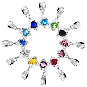 May include: A set of 12 silver charm beads with heart-shaped pendants. Each pendant features a different colored crystal in the center. The charms are perfect for adding a touch of sparkle to bracelets, necklaces, or keychains.