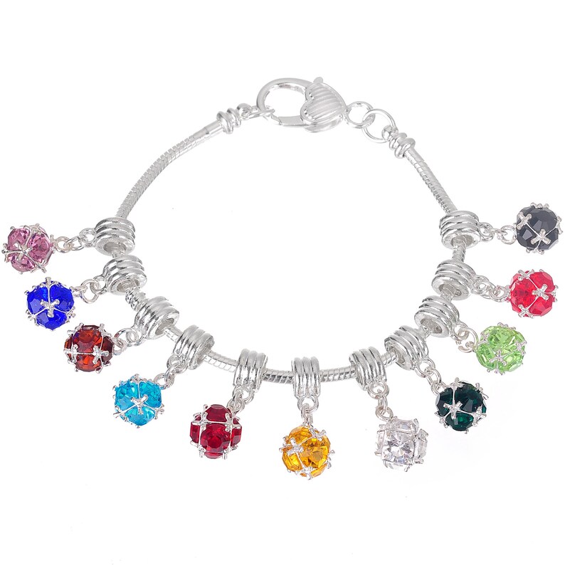 May include: A silver charm bracelet with a heart-shaped clasp and multiple dangling charms. Each charm is a small sphere with a different coloured crystal inside. The crystals are pink, blue, red, turquoise, red, yellow, clear, and green.