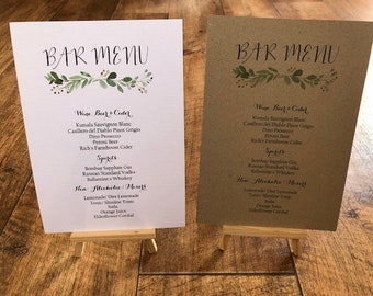 May include: Two brown and white bar menus with a green leafy design and the words "Bar Menu" written in black calligraphy. The menus list wine, beer, cider, spirits, and non-alcoholic beverages.