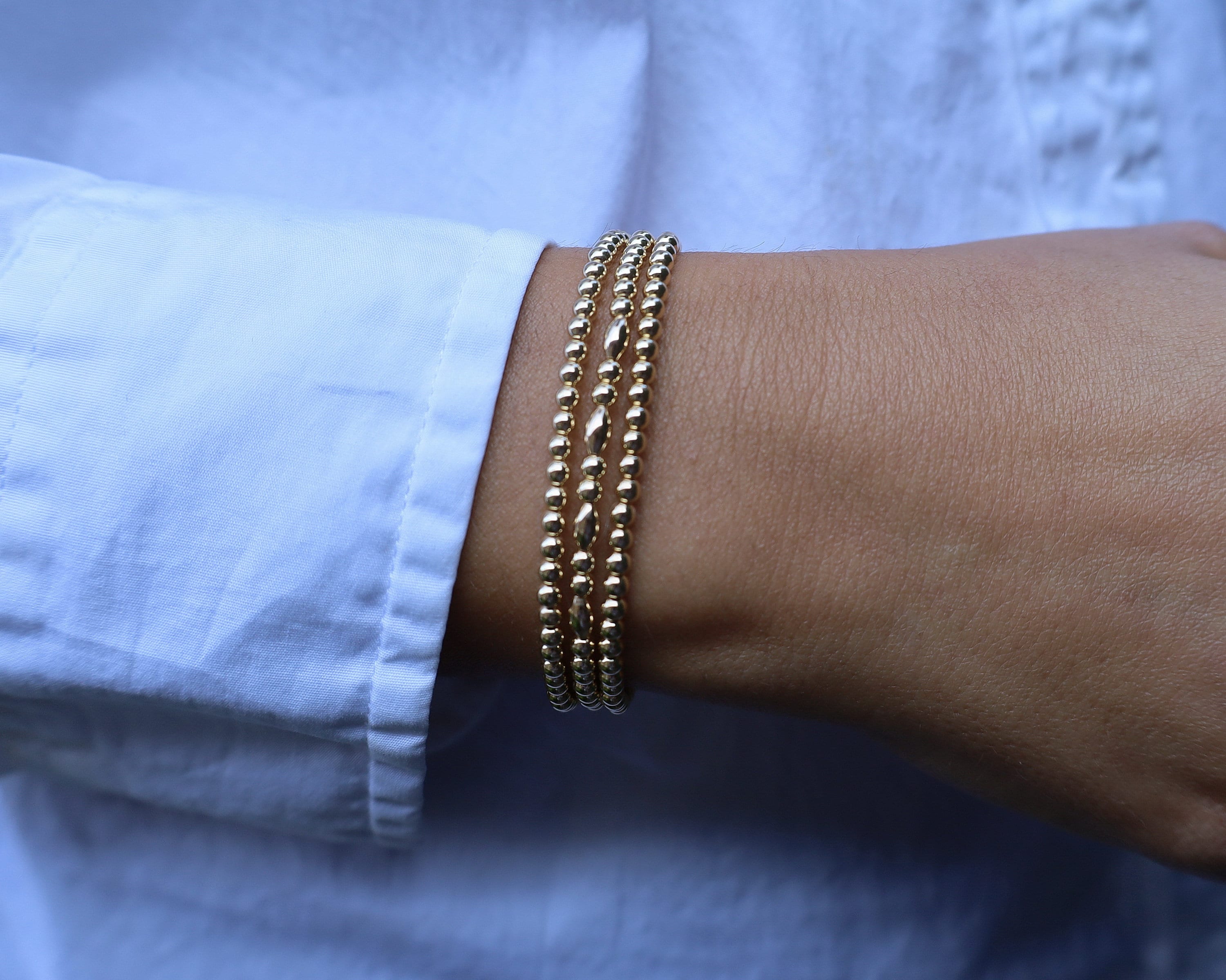 Bracciale con perle impilabili: perle riempite d'oro - elastico regolabile - Italia